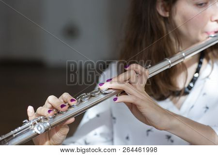 Girl Plays On Flute. Flute In Hands Of Girl During The Concert. Professional Musician Playing On Flu