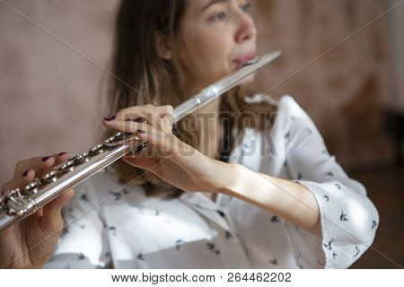 Girl Plays On Flute. Flute In Hands Of Girl During The Concert. Professional Musician Playing On Flu