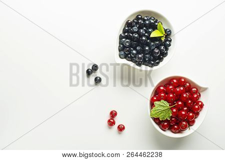 Blueberries And Red Currant On Isolated White Background