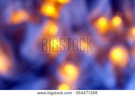 Background Of Blurry Blue-blue Lights Of The Christmas-tree Garland On The Dark. Copy Space