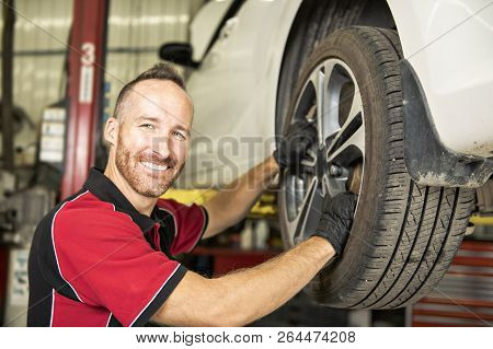 Handsome Mechanic Based On Car In Auto Repair Shop