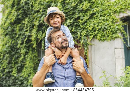 Dad With Her Son Outside In A Urban Street