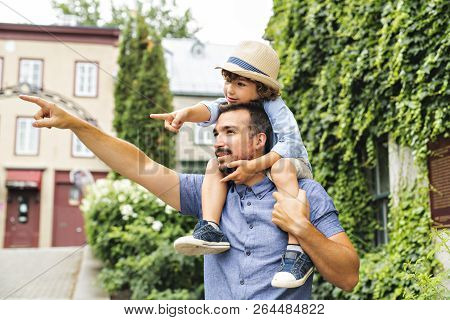 Dad With Her Son Outside In A Urban Street