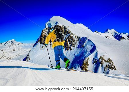 Skitouring with amazing view of swiss famous mountains in beautiful winter powder snow of Alps. 