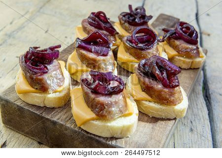 Croutons Of Bread With Cheese Sausage And Caramelized Onion