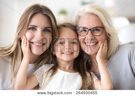 Portrait Of Girl Hugging Mom And Grandmother Making Family Pictu