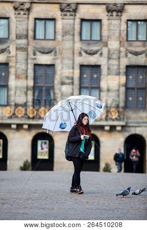 Amsterdam, Netherlands- March, 2018: Free Walking Tour Guide At Dam Square In Amsterdam