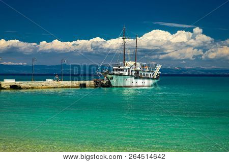 View Of Ship Boat On Blue Paradise Water Of Toroneos Kolpos Gulf, Blue Sky, White Clouds Over Sithon