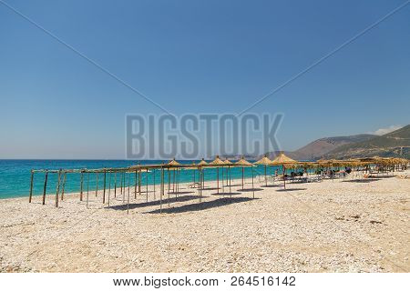 Borsh, Albania- 29 June 2014: Sunbathers On The Beach In Borsh Resort. Stony Beach On The Adriatic S