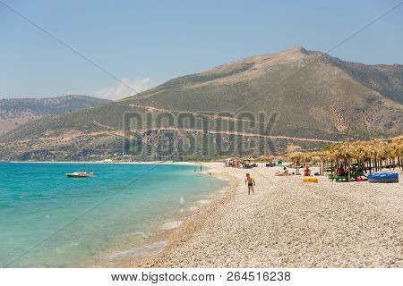 Borsh, Albania- 29 June 2014: Sunbathers On The Beach In Borsh Resort. Stony Beach On The Adriatic S
