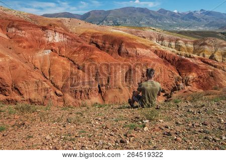 Relaxing man in Valley of Mars landscapes in the Altai Mountains, Kyzyl Chin, Siberia, Russia