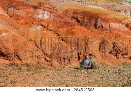Relaxing man and woman in Valley of Mars landscapes in the Altai Mountains, Kyzyl Chin, Siberia, Russia