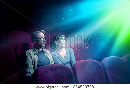 Teenager couple cuddling and watching the climax part of the movie