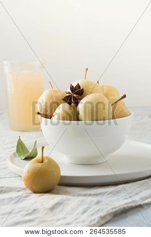 Pickled Apples In Bowl And Apple Sidr On White Stone Table.
