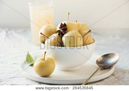 Pickled Apples In Bowl And Apple Sidr On White Stone Table.