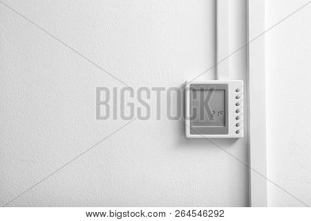 Modern Thermostat And Space For Text On White Wall. Heating System