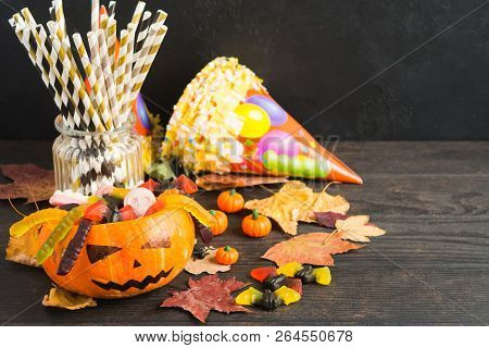 Autumn Halloween Table With Leaves, Paer Straws And Candies