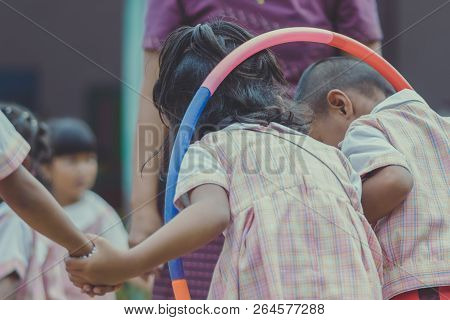 Young Kids Exercise With Hoola Hoop In The Morning.