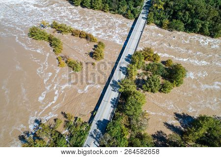 Austin Flood Waters Rush Down The Colorado River Under Bridge At Red Bud Isle Towards Longhorn Dam A