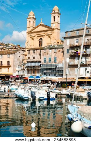 BASTIA, FRANCE - SEPTEMBER 16, 2018: A view of the Vieux Port, the Old Port of Bastia, in Corsica, France, highlighting the Saint-Jean-Baptiste Church with its characteristic twin bell towers