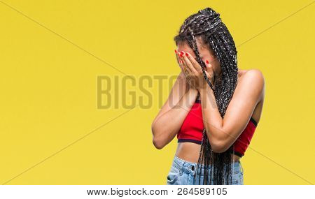 Young braided hair african american with pigmentation blemish birth mark over isolated background with sad expression covering face with hands while crying. Depression concept.