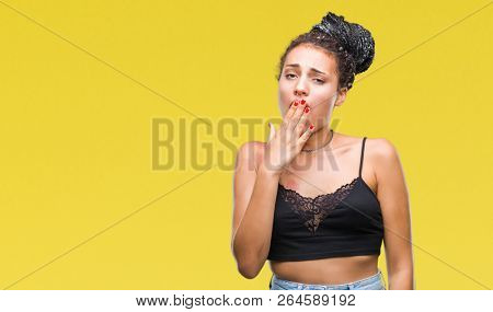 Young braided hair african american with pigmentation blemish birth mark over isolated background bored yawning tired covering mouth with hand. Restless and sleepiness.