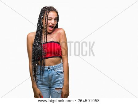 Young braided hair african american with pigmentation blemish birth mark over isolated background winking looking at the camera with sexy expression, cheerful and happy face.