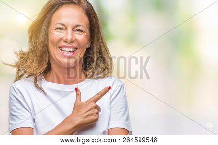 Middle age senior hispanic woman over isolated background cheerful with a smile of face pointing with hand and finger up to the side with happy and natural expression on face looking at the camera.