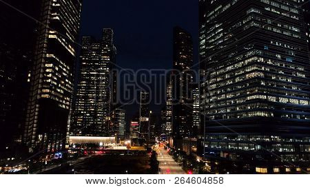 Exterior Picturesque Modern Skyscrapers With Glowing Windows Of Offices In Evening. Shot. The Concep