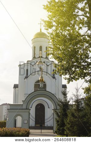 White Orthodox Church On The Background Of Bright Sky.