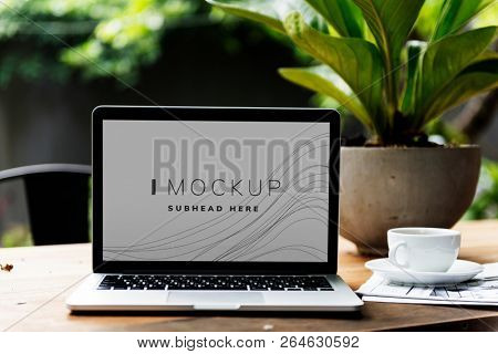 Laptop in a garden with a screen mockup