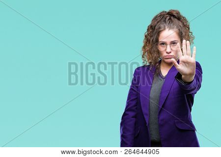 Young brunette student girl wearing school uniform and glasses over isolated background doing stop sing with palm of the hand. Warning expression with negative and serious gesture on the face.