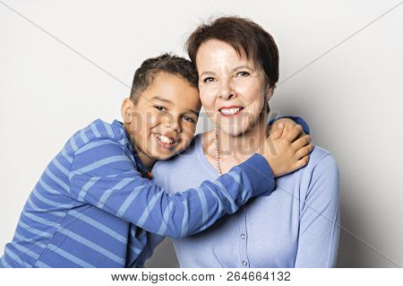 Black Boy With Grandmother In Studio White Background