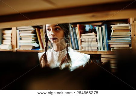Girl With Pigtails In White Blouse At Old Library.