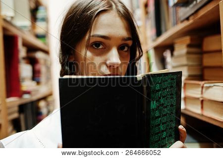 Girl With Pigtails In White Blouse At Old Library.