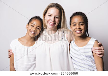 White Skin Caucassian Mother With Black Twin In Studio White