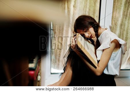 Girl With Pigtails In White Blouse At Old Library.