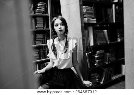 Girl With Pigtails In White Blouse At Old Library.