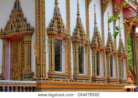 Doors And Windows Of The Temple Adorned By Intricate Wooden Carvings In Golden Color Depicting Buddh