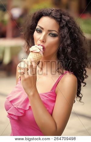 Portrait Of Sexual Pretty Brunette Lady With Curly Hair And Bright Makeup Eating Cold Dessert Of Red