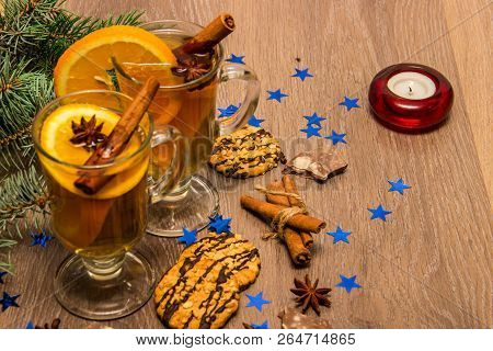 Two Glasses With Delicious Fragrant Tea Of Mulled Wine With Orange And Spices On A Wooden Board With