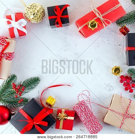 Christmas Decorative Background With Fir Branches, Cones, Redr And Black Christmas  Gifts, Ball On T