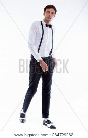 Full Body Shot Of Young Handsome Man Walking While Wearing Suspe