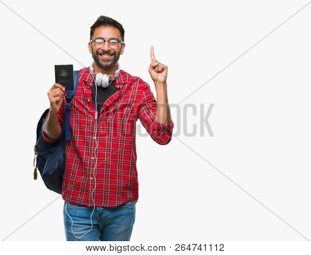 Adult hispanic student man holding passport of australia over isolated background surprised with an idea or question pointing finger with happy face, number one