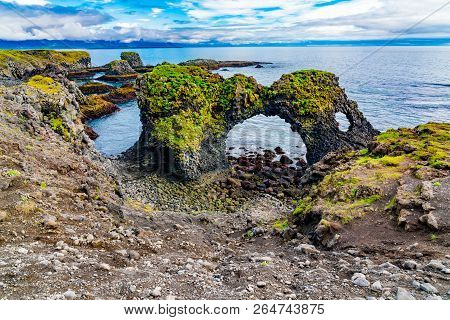 View Of Gatklettur Arch Rocks Formation At The Coast Of Atlantic Ocean In Arnarstapi Village In Icel