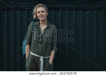 Urban People Concept. Carefree Young Woman Portrait Smiling, Dressed In A Khaki Romper With A Backpa