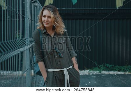 Urban People Concept. Carefree Young Woman Portrait Smiling, Drssed In Chaki Romper. City Lifestyle 