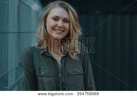 Urban People Concept. Carefree Young Woman Portrait Smiling, Drssed In Chaki Romper. City Lifestyle 