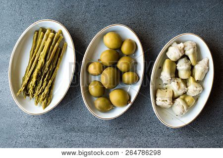 Pickled Vegetables Green Asparagus, Artichoke Heart And Unripe Green Almond Pickles In Plate.