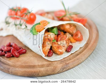 Delicious mexican wrap with chicken stripes and vegetable